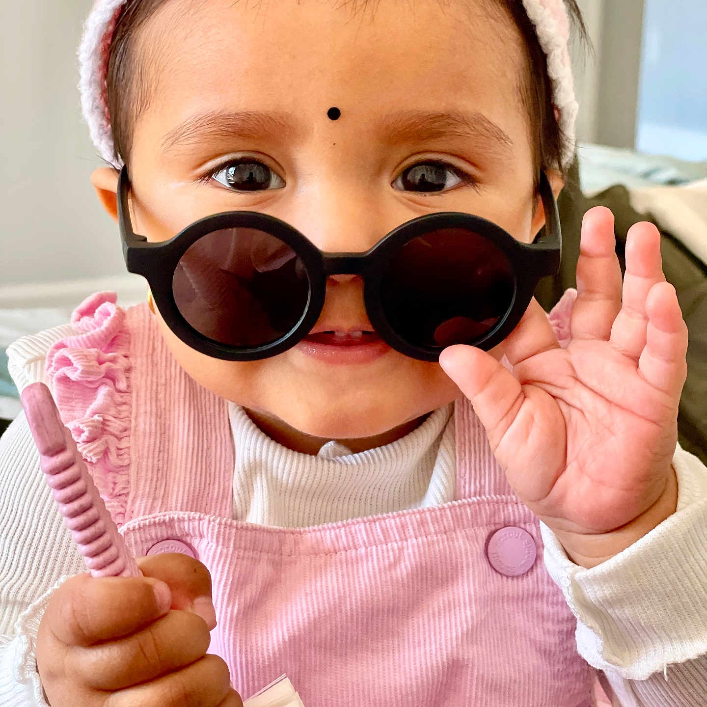 Saarin is registered to the contest to win money with this photo: accessories, baby, bodypart, brush, cap, clothing, device, face, finger, glasses, hand, happy, hat, head, person, photography, portrait, smile, sunglasses, tool