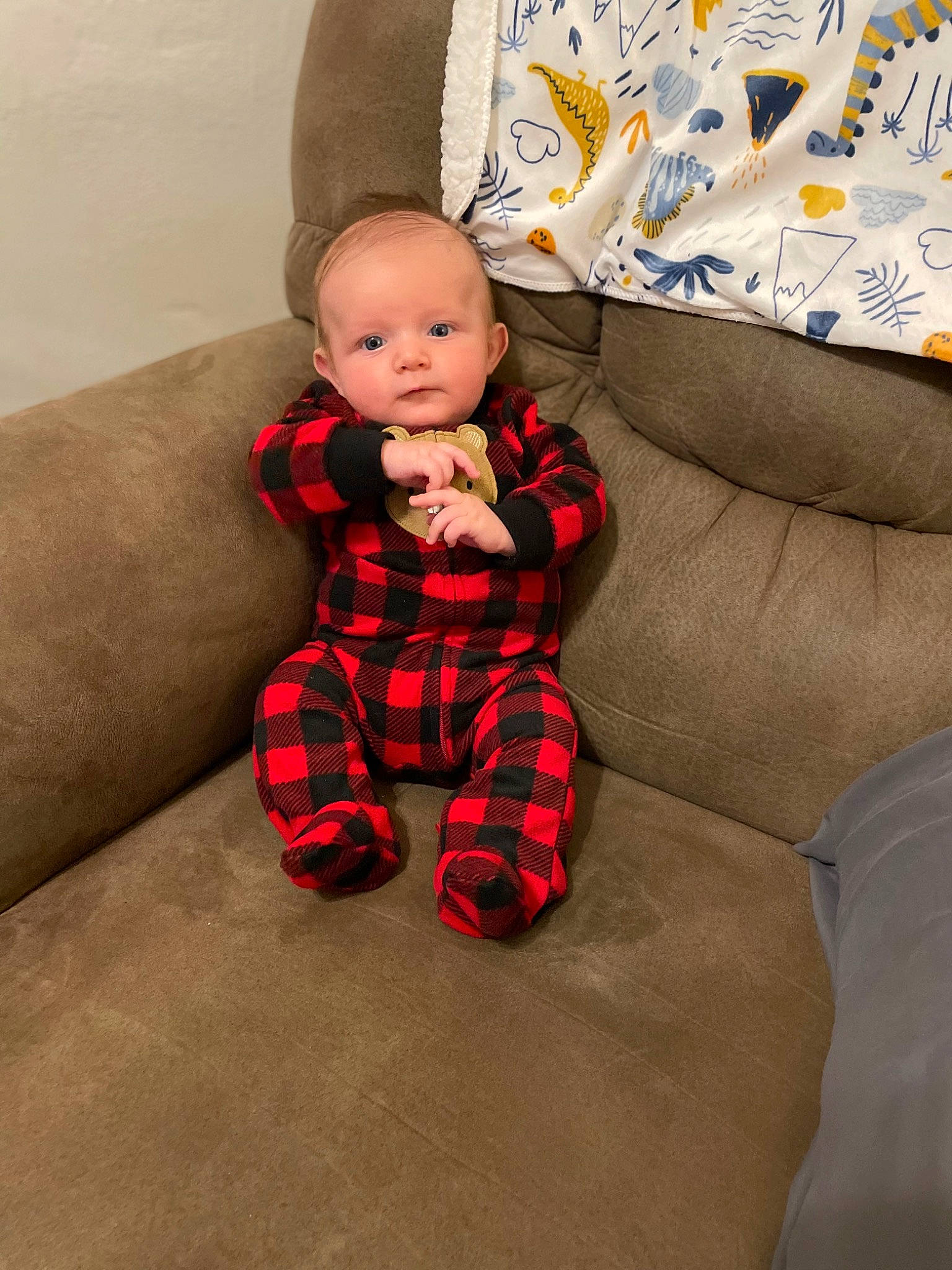 Kace joined the competition — help win amazing prizes! baby, baby_toddler_clothing, child, comfort, couch, human_leg, knee, lap, leg, linens, living_room, pattern, person, pillow, plaid, sitting, sleeve, sock, tartan, thigh