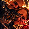 cat, people, couple, portrait, pet, tabby_cat, glasses, smiling, affection, cuddling, close_up, indoor, warm_lighting, glowing_effects, heart_symbols, text_overlay, family, whiskers, furry, dramatic_lighting