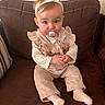 Lou participe au concours pour gagner de l'argent avec cette photo : baby, child, pacifier, headband, pink_outfit, ruffles, couch, brown_couch, sitting, blue_eyes, cute, indoor, portrait, infant, clothing, socks, hands, face, young_child, adorable