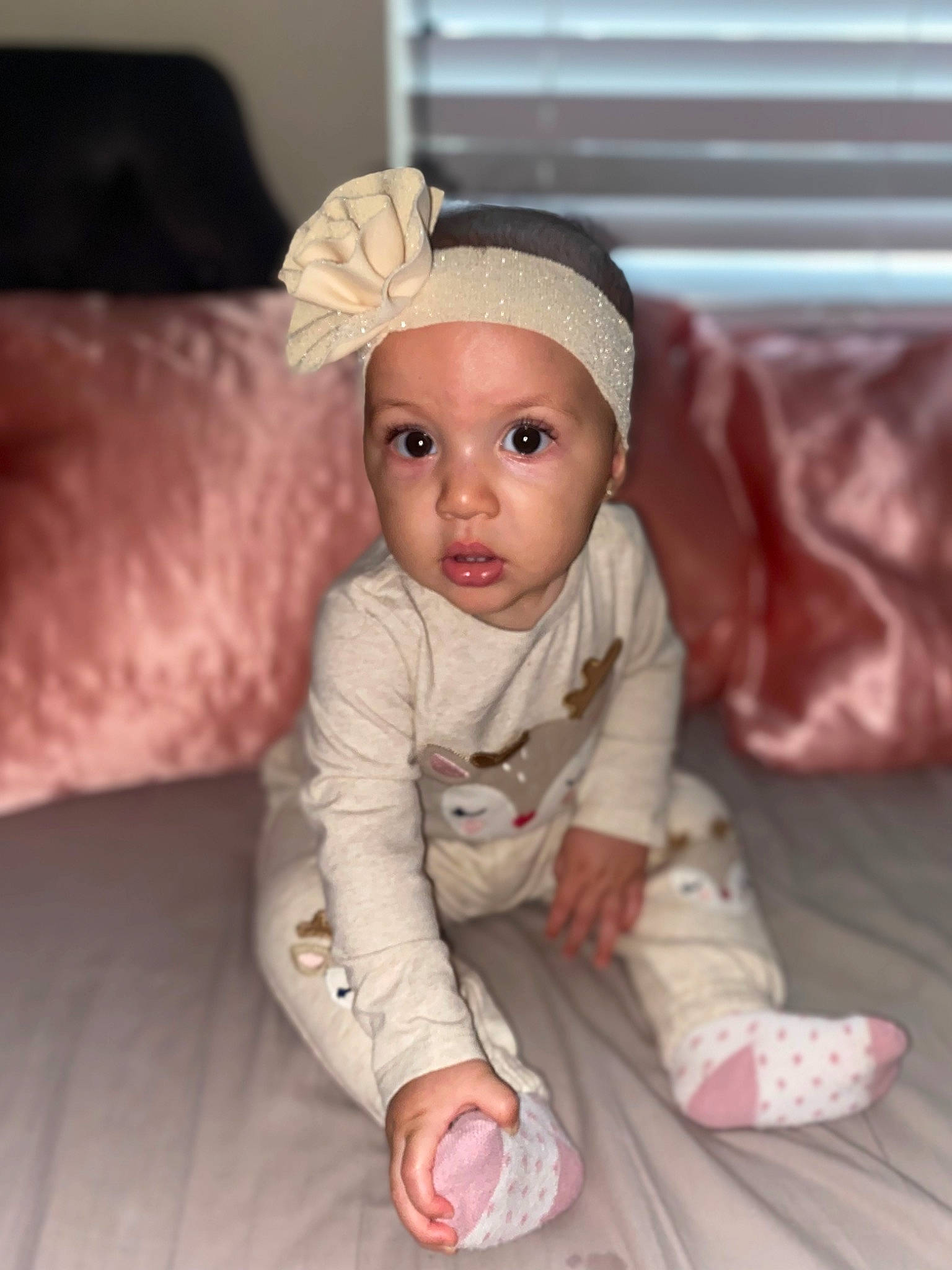 Na Ilah is registered to the contest to win money with this photo: baby, baby_toddler_clothing, cap, cheek, child, chin, comfort, costume_hat, couch, eye, face, flooring, fur, headwear, linens, person, pink, room, sitting, sleeve