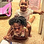 child, baby, notebook, pen, carpet, toy_car, indoor, drawing, smiling, happy, play, baby_clothes, toddler, person, hair, floor, room, door, basket, cute