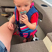 Desiree is registered to the contest to win money with this photo: baby, clothing, coat, cream, dessert, face, food, footwear, head, icecream, jacket, lifejacket, pants, person, photography, portrait, shorts, summer, vest, water