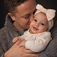 Brielle joined the competition — help win amazing prizes! baby, child, father, smile, hug, love, portrait, headband, sweater, cute, family, affection, warm, closeup, hands, skin, person, indoor, happy, parent