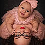 Brielle is registered to the contest to win money with this photo: baby, woman, glasses, pink_dress, headband, smile, portrait, closeup, love, mother_and_child, happy, face, child, toddler, curly_hair, red_lipstick, person, indoor, fashion, cute