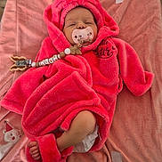 Alba participe au concours pour gagner de l'argent avec cette photo : baby, newborn, infant, pacifier, pacifier_clip, pink_robe, hood, blanket, plush_blanket, diaper, bare_foot, sleepy, beads, clip, soft_texture, cozy, lying_down, wooden_floor, cute, person