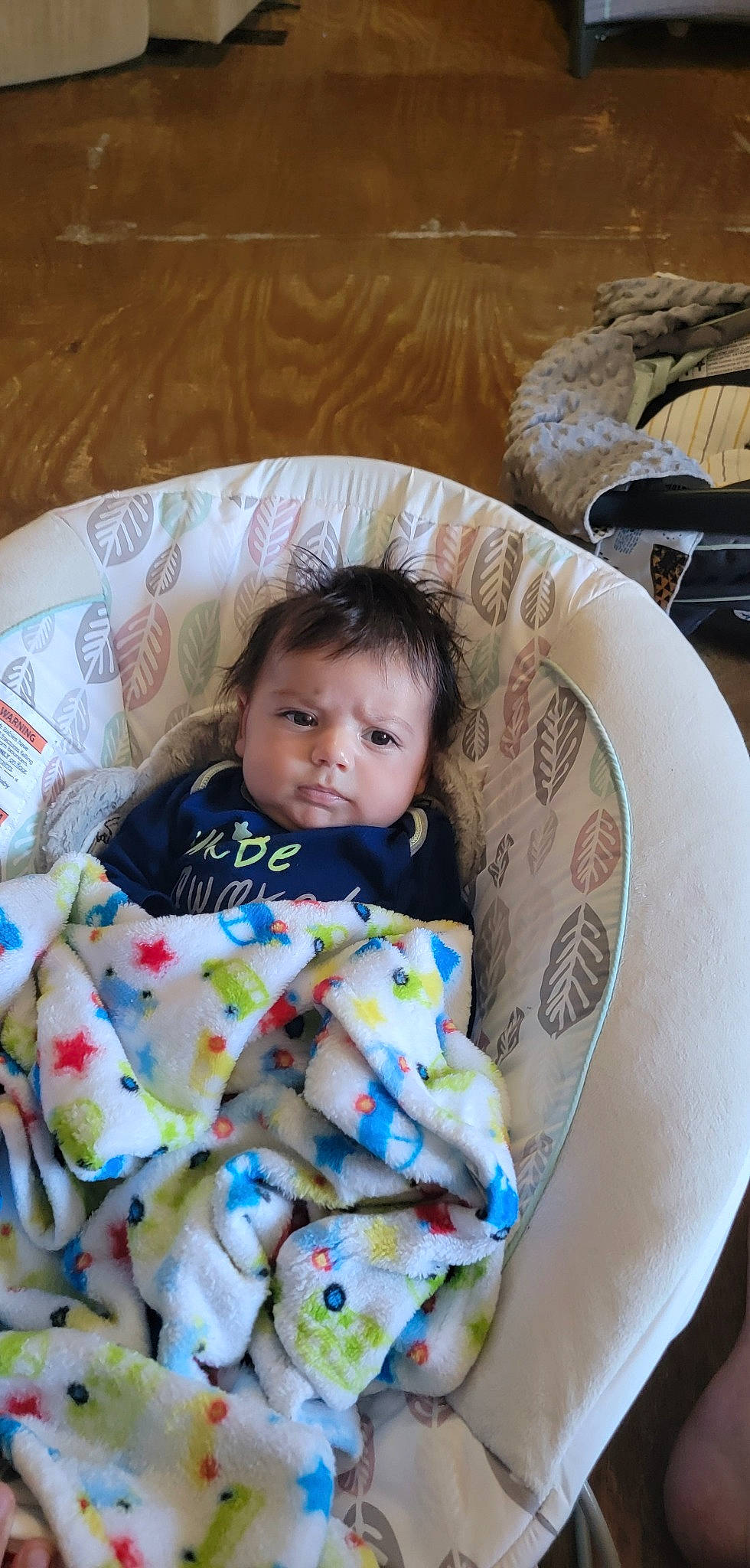 Elian is registered to the contest to win money with this photo: baby, baby_toddler_clothing, bedding, bedtime, chair, child, comfort, couch, dishware, event, face, head, linens, pattern, person, sitting, sleeve, tableware, textile, toddler