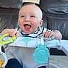 baby, smiling, blue_eyes, toy, baby_seat, indoor, living_room, furniture, happy, infant, child, clothing, foot, hand, face, person, couch, teether, striped_shirt, playtime