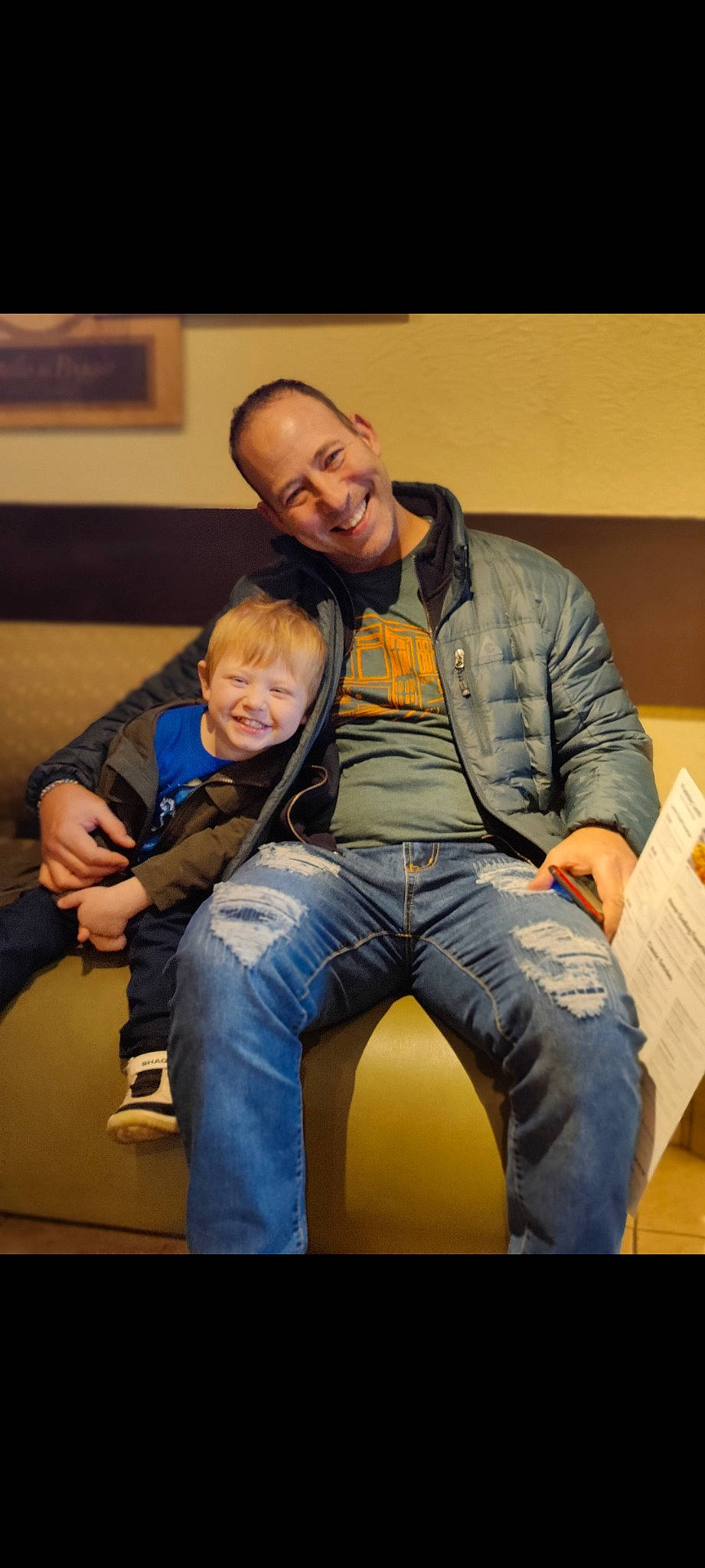 Greyson is registered to the contest to win money with this photo: comfort, conversation, couch, denim, event, eyewear, flash_photography, flooring, fun, happy, interaction, jeans, joy, lap, leisure, person, room, shoe, sitting, smile