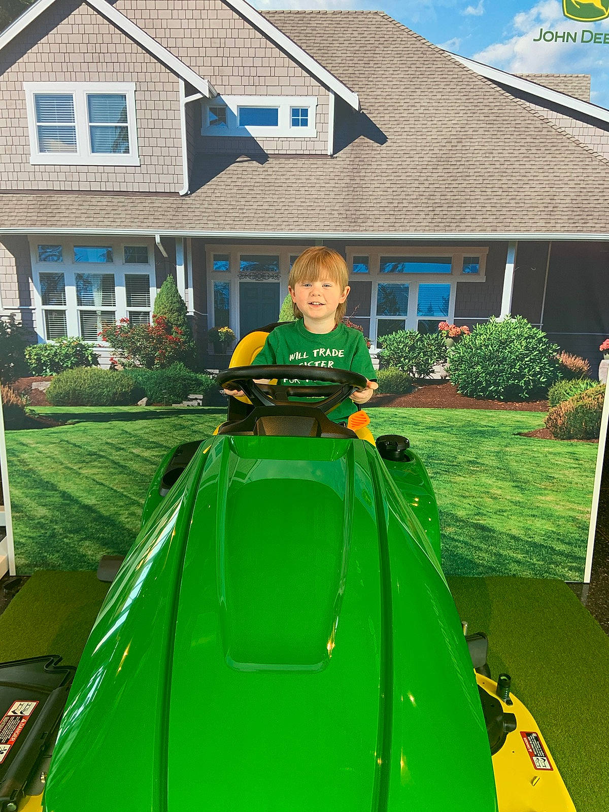 Greyson joined the competition — help win amazing prizes! automotive_exterior, fun, grass, green, hood, house, jacket, joy, lawn, leisure, motor_vehicle, outdoor_recreation, person, plant, property, recreation, shade, sky, toddler, vehicle