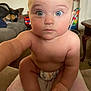 Jameson is registered to the contest to win money with this photo: baby, child, diaper, blue_eyes, curious, indoor, furniture, living_room, skin, hand, foot, toy, table, couch, person, infant, closeup, cute, expression, home