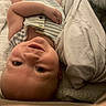 Danny joined the competition — help win amazing prizes! baby, blanket, child, comfort, cozy, cute, expression, face, hand, head, indoors, infant, lying_down, person, portrait, resting, smile, soft_texture, striped_clothing, young