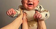 Danny joined the competition — help win amazing prizes! baby, child, smile, hands, feet, playing, joyful, onesie, indoor, happy, person, infant, cute, skin, face, expression, human, holding, background, tattoo