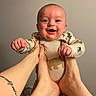 Danny joined the competition — help win amazing prizes! baby, child, smile, hands, feet, playing, joyful, onesie, indoor, happy, person, infant, cute, skin, face, expression, human, holding, background, tattoo