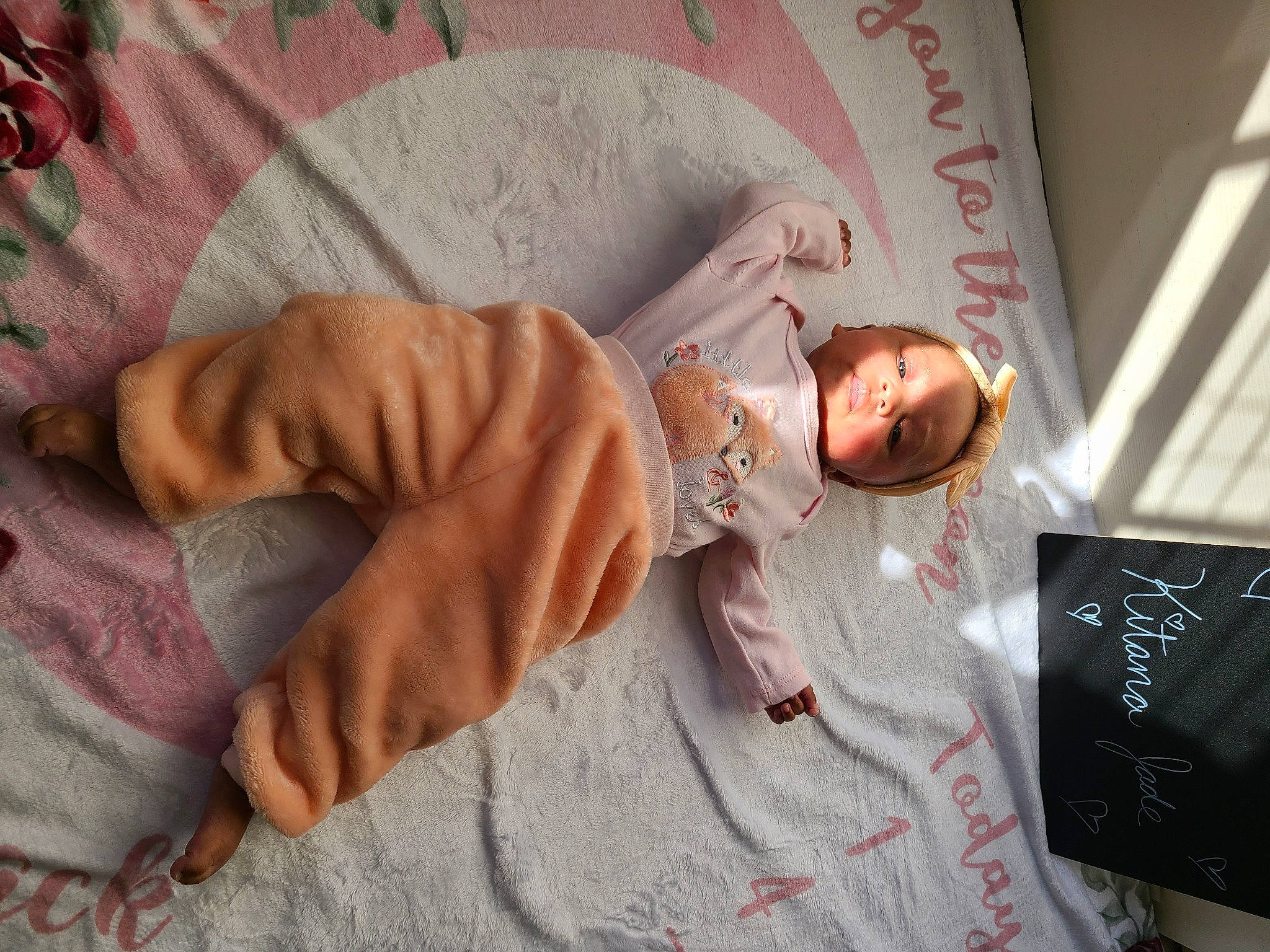 Kitana is registered to the contest to win money with this photo: baby, bedtime, child, comfort, eyewear, flesh, fun, linens, pattern, people, person, pink, room, sitting, skin, sleep, toddler, wood