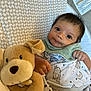 Sevenn joined the competition — help win amazing prizes! baby, infant, plush_toy, teddy_bear, blanket, pattern, sleepwear, cute, child, indoor, portrait, soft_toy, young_child, face, eyes, hand, cozy, resting, nursery, smiling