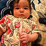 baby, blanket, bodypart, clothing, couch, cutlery, dress, face, finger, hand, happy, head, person, photography, portrait, quilt, sleeve, smile, spoon, t_shirt
