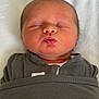 August joined the competition — help win amazing prizes! newborn, baby, sleeping, puckered_lips, swaddled, blanket, infant, closeup, face, head, peaceful, soft, cozy, skin, person, indoors, portrait, cute, resting, child