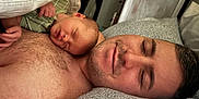 August is registered to the contest to win money with this photo: baby, newborn, sleeping, man, adult, skin, bed, pillow, blanket, face, peaceful, rest, closeup, indoor, family, love, comfort, relaxation, human, portrait