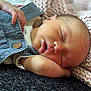 baby, sleeping, denim, overalls, blanket, knitted, infant, peaceful, resting, soft_lighting, closeup, face, hand, skin, cozy, portrait, child, newborn, relaxation, comfort