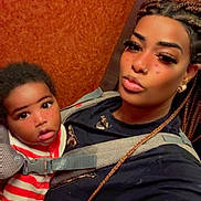 Cheikhou participe au concours pour gagner de l'argent avec cette photo : child, baby, adult, selfie, elevator, baby_carrier, braided_hair, nose_ring, striped_sweater, face_filter, heart_stickers, wide_eyes, pout, close_up, portrait, indoor, wooden_panel, earrings, strap, family_moment