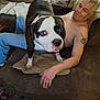 Jack joined the competition — help win amazing prizes! dog, large_dog, pitbull, person, man, shirtless, tattoo, sofa, couch, living_room, blanket, pillow, chain_collar, hand, sitting, relaxed, indoors, rug, portrait, red_eye