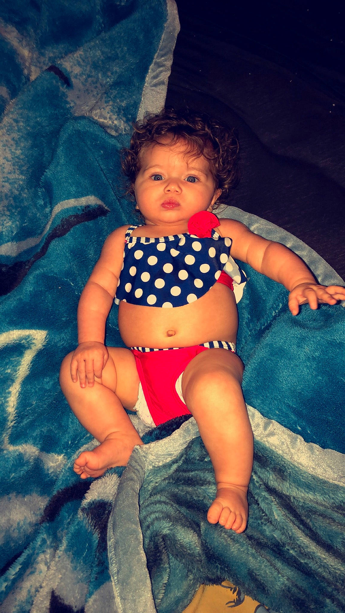 Liberty is registered to the contest to win money with this photo: abdomen, baby, child, eye, fun, human_leg, leg, lip, pattern, person, sitting, skin, smile, stomach, thigh, toddler, trunk, vacation