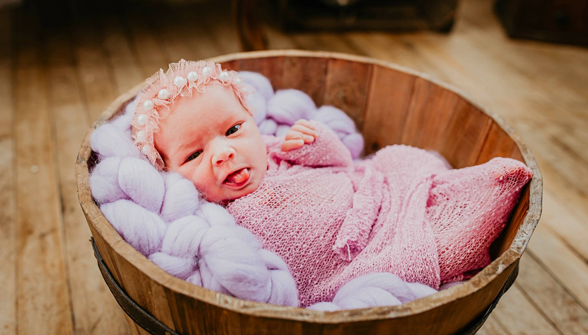 Haisley is registered to the contest to win money with this photo: baby, baby_products, baby_safety, baby_sleeping, baby_toddler_clothing, basket, cheek, child, comfort, fashion_accessory, fur, happy, head, infant_bed, linens, person, pink, sitting, toddler, wool