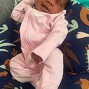 Jakiyilah is registered to the contest to win money with this photo: baby, infant, smiling, pink_onesie, cushion, patterned_fabric, sleeping, cozy, child, resting, indoor, cute, small_hands, soft_lighting, portrait, comfort, relaxation, happy, peaceful, person