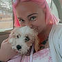 car_interior, closeup, cute, dog, face, fur, holding, indoors, leash, natural_light, patterned_dress, person, pet, pink_hair, puppy, smiling, sunglasses, tattoo, white_clothing, window