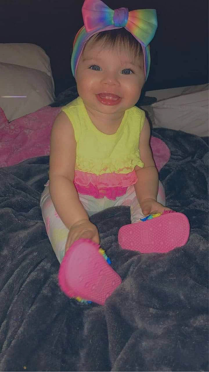 Aniyaah is registered to the contest to win money with this photo: arm, baby_toddler_clothing, cheek, eye, face, facial_expression, hairstyle, happy, head, human_body, joy, lip, mammal, mouth, organ, person, pink, purple, skin, sleeve