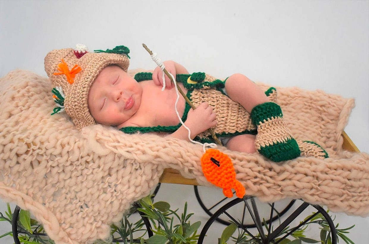 Rhett joined the competition — help win amazing prizes! art, baby, baby_toddler_clothing, cap, chair, comfort, craft, creative_arts, fashion_accessory, fawn, grass, headgear, headwear, knit_cap, linens, pattern, person, plant, textile, toddler
