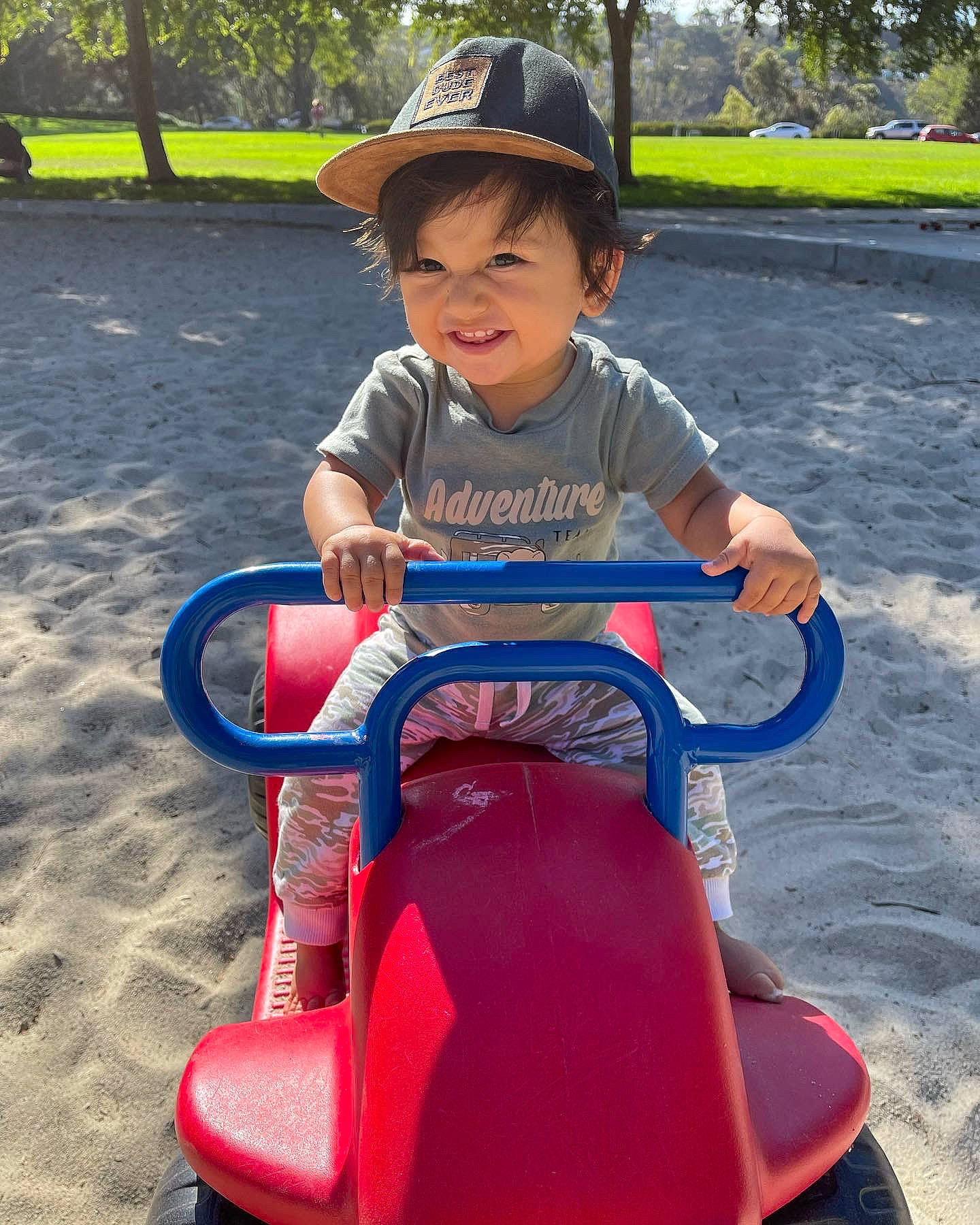 Andy joined the competition — help win amazing prizes! baby_toddler_clothing, cap, child, city, electric_blue, face, fun, grass, happy, hat, leisure, person, plant, recreation, riding_toy, sitting, snapshot, sun_hat, toddler, tree