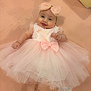 Everli is registered to the contest to win money with this photo: baby, child, pink_dress, headband, smile, cute, toddler, footwear, lace_socks, floor_mat, portrait, happy, infant, bow, soft_texture, indoor, fashion, hand_jewelry, shoes, playtime
