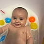 Everli is registered to the contest to win money with this photo: baby, bath, bubbles, foam, toy, colorful, smiling, happy, water, skin, infant, child, floating, playful, cute, tub, bathroom, arm, bracelet, star