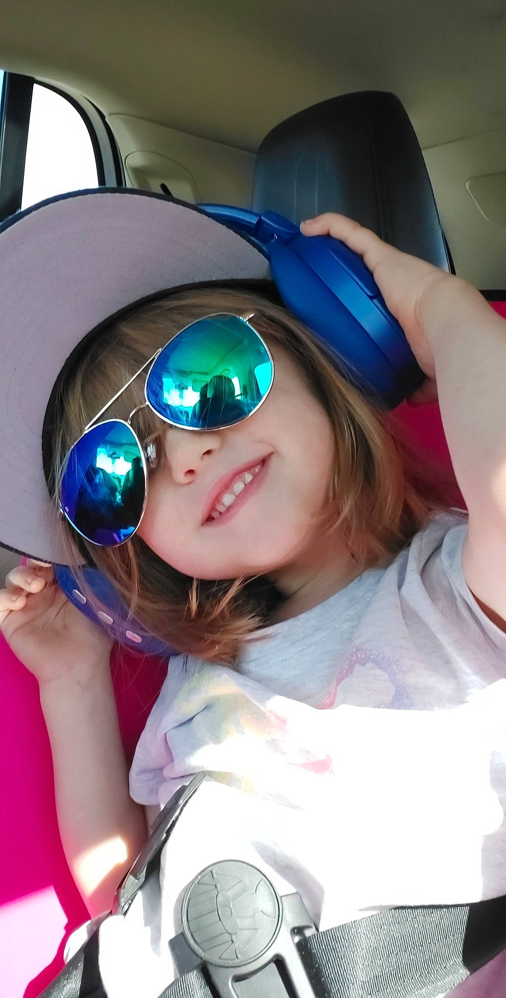 Mckenzi is registered to the contest to win money with this photo: audio_equipment, automotive_design, automotive_lighting, child, cool, costume, electric_blue, event, eyewear, fun, goggles, hairstyle, happy, headgear, headwear, person, personal_protective_equipment, purple, smile, sunglasses