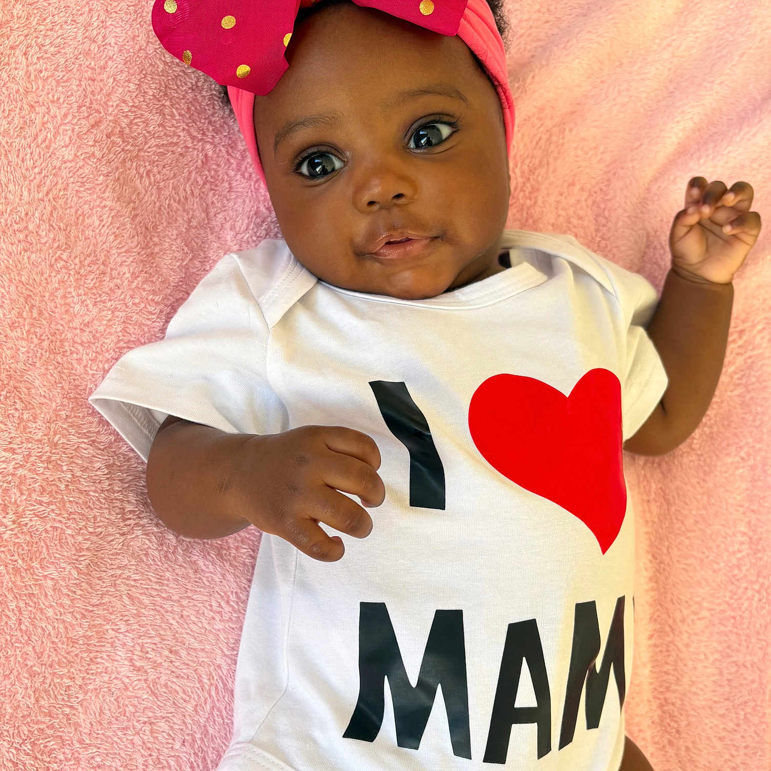 Chimfumnanya Or Naya is registered to the contest to win money with this photo: adorable, baby, bow, child, closeup, cute, hand, happy, headband, infant, laying_down, love_message, onesie, pink_blanket, polka_dots, portrait, skin, smiling, soft_texture, toddler