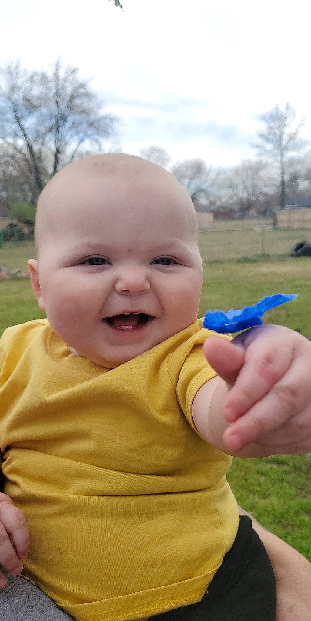 Isaac is registered to the contest to win money with this photo: baby, baby_toddler_clothing, cheek, cloud, finger, gesture, grass, happy, iris, joy, lip, nose, people_in_nature, person, pink, plant, skin, sky, smile, thumb