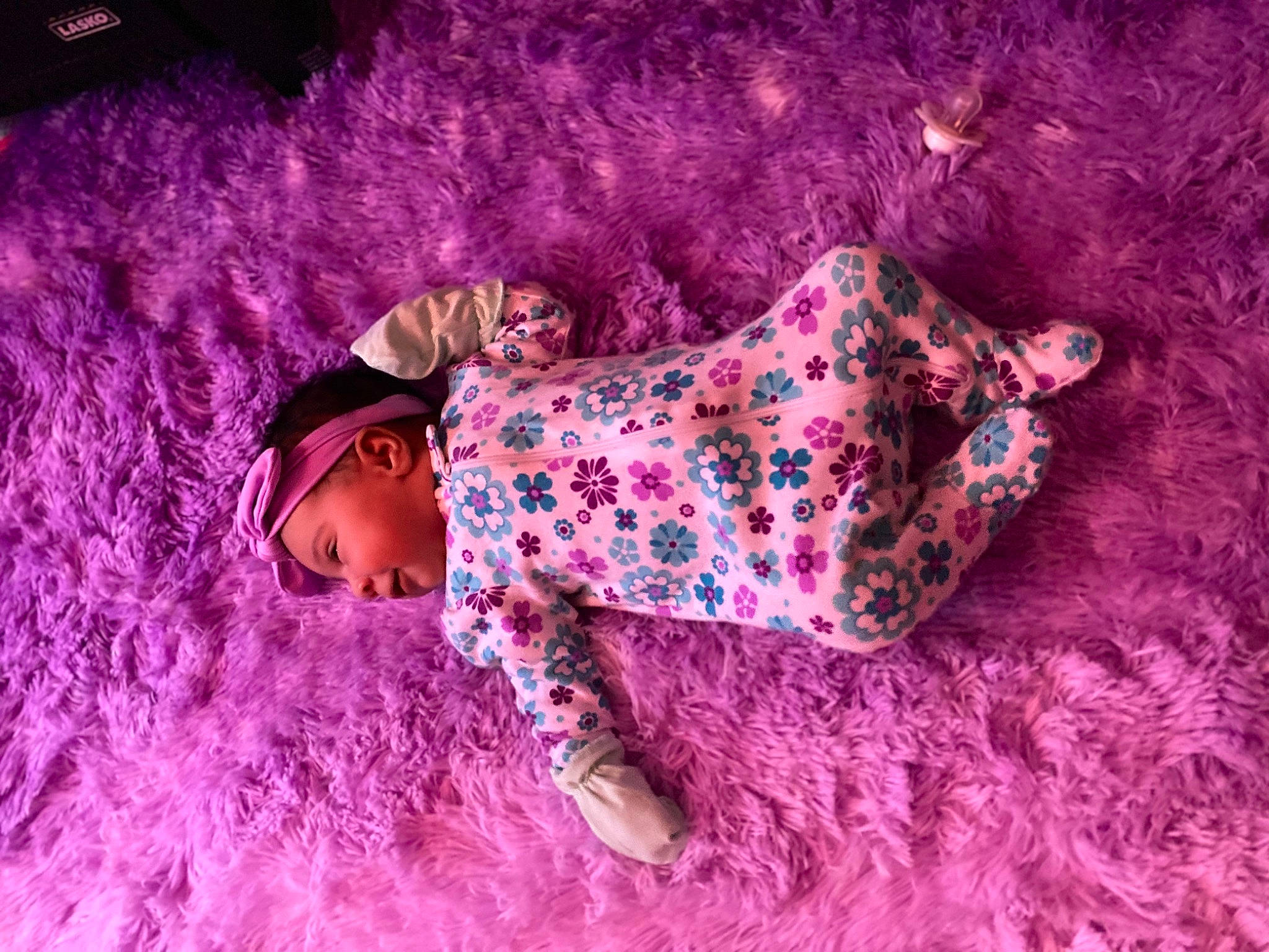 Maya is registered to the contest to win money with this photo: baby, baby_toddler_clothing, child, comfort, doll, flooring, fun, fur, grass, linens, magenta, pattern, person, pink, purple, sleeve, toddler, toy, tree, violet