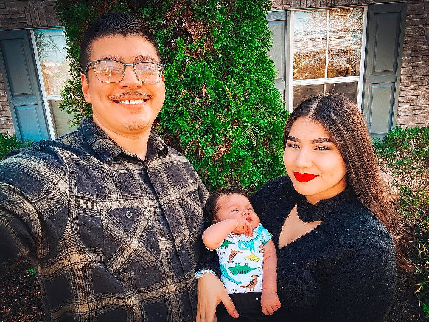 Valentine is registered to the contest to win money with this photo: arm, baby, baby_toddler_clothing, eye, face, family, family_taking_photos_together, glasses, hair, happy, head, holiday, human, joy, laugh, love, people, person, plaid, shirt