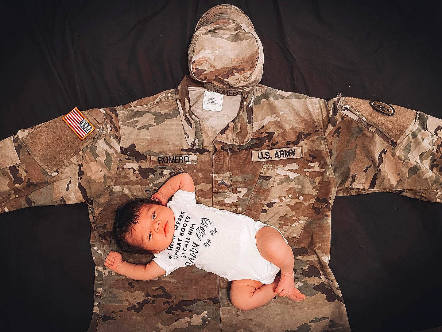 Valentine is registered to the contest to win money with this photo: army, baby_toddler_clothing, camouflage, clothing, collar, medical, medical_procedure, military, military_camouflage, military_officer, military_organization, military_person, military_uniform, pattern, person, service, sleeve, soldier, space, uniform