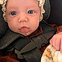baby, infant, face, eyes, bonnet, clothing, car_seat, harness, blanket, hand, soft_texture, portrait, closeup, child, cute, expression, indoors, person, newborn, warm