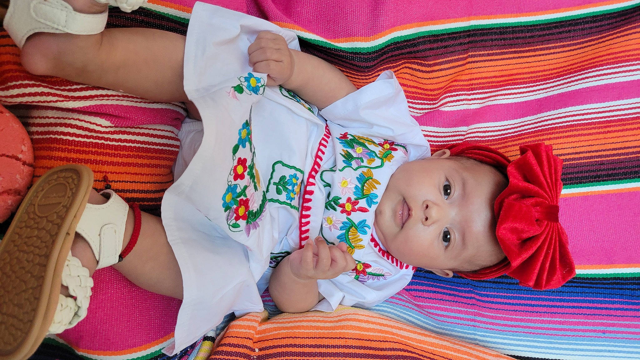 Arya is registered to the contest to win money with this photo: abdomen, baby, baby_products, baby_toddler_clothing, chest, child, grass, hand, happy, human_leg, nail, orange, pattern, person, pink, product, sitting, skin, thigh, toddler