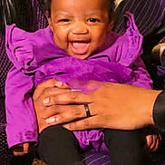 Semaj joined the competition — help win amazing prizes! baby, child, smiling, purple_clothing, bow, hands, holding, indoor, portrait, cute, happy, infant, person, black_hair, sitting, toddler, black_legwear, closeup, family, joyful