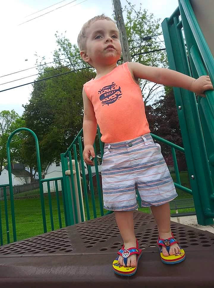 Kyrin is registered to the contest to win money with this photo: child, green, leisure, person, shorts, shoulder, smile, standing, summer, t_shirt, toddler, vacation