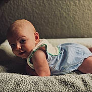 Silas is registered to the contest to win money with this photo: baby, infant, child, lying_down, blanket, textured, clothing, onesie, skin, face, head, eyes, expression, cute, adorable, indoor, soft_light, background, portrait, toddler