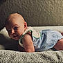 baby, infant, child, lying_down, blanket, textured, clothing, onesie, skin, face, head, eyes, expression, cute, adorable, indoor, soft_light, background, portrait, toddler