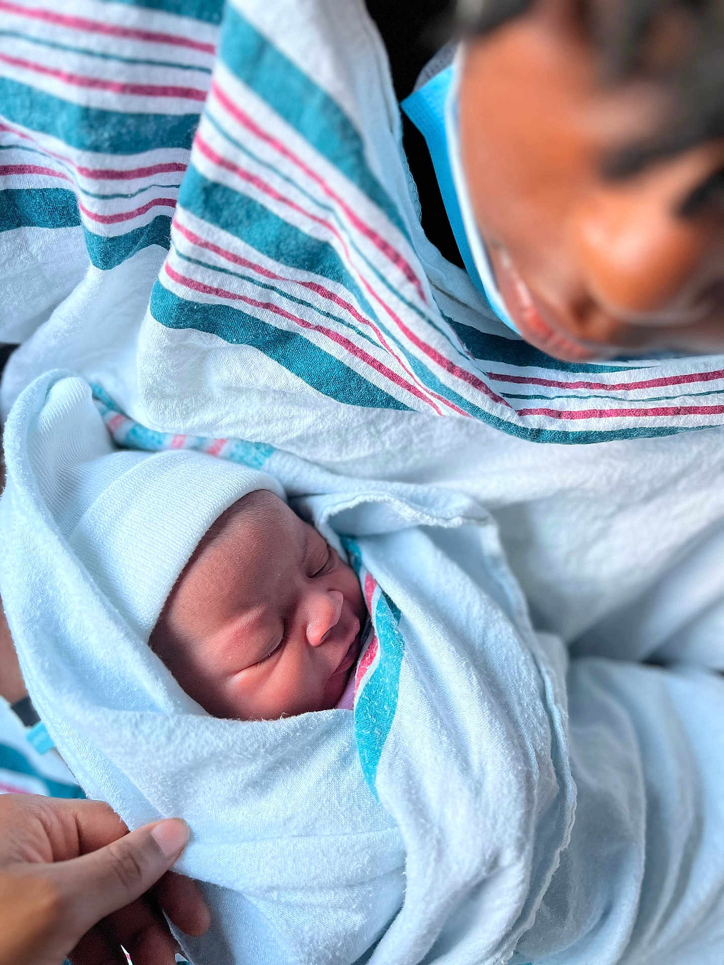 Asaya Love joined the competition — help win amazing prizes! newborn, baby, blanket, hospital, person, face, mask, hand, wrapped, sleeping, infant, closeup, soft, tender, parent, care, cloth, striped_blanket, skin, portrait