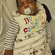 Jean Uriel participe au concours pour gagner de l'argent avec cette photo : baby, blanket, child, circus, circus_tent, comfort, cozy, cute, dumbo, hand, indoors, infant, koala, pacifier, portrait, sleep, sleeping, soft_toy, striped_clothing, train