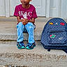 Jayvier is registered to the contest to win money with this photo: child, boy, sitting, steps, backpack, school, outdoor, portrait, fashion, sneakers, jeans, shirt, peace, door, concrete, serious, face, clothing, daylight, street